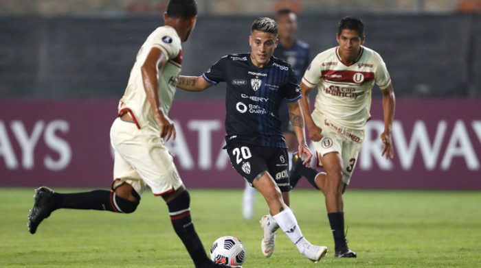 Cristian Ortiz (c) de Independiente avanza con el balón ante dos jugadores de Universitario, en Lima, el 18 de mayo del 2021. Foto: EFE