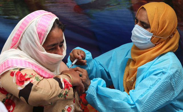 Una mujer recibe una inyección de la vacuna contra el covid-19, durante la prueba rápida de antígenos y la campaña de vacunación en Srinagar, la capital de verano de la Cachemira india, el 05 de julio de 2021. Foto: EFE