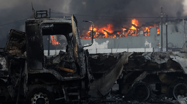 Un negocio y un camión se incendian durante los saqueos y protestas generalizados en Durban, Sudáfrica, el 12 de julio de 2021. Foto: EFE