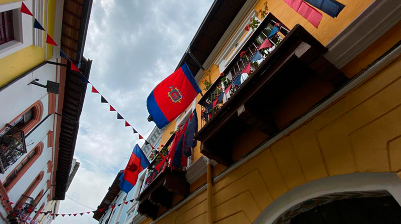 Vecinos del Centro Histórico adornan las fachadas de su casa con banderas de Quito. Foto: Patricio Terán / EL COMERCIO