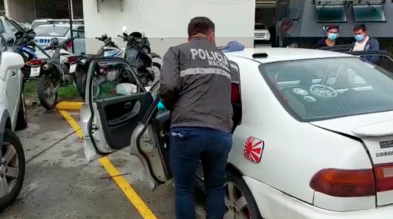 Agente inspecciona un auto, donde se encontraron paquetes con heroína, en Guayaquil. Foto: Policía
