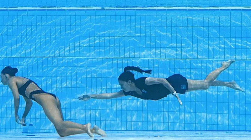 El momento que la entrenadora Andrea Fuentes se acerca a la nadadora Anita Álvarez, quien perdió el conocimiento en plena competencia en el mundial de natación. Foto de Oli Scarff, tomada de la cuenta Twitter @FCabezas78