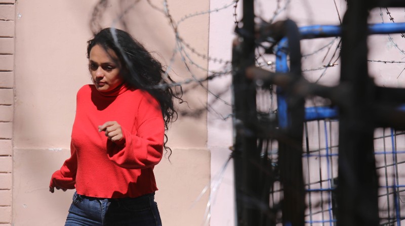 Una mujer intenta cruzar la calle en medio de barreras metálicas. El riesgo es permanente en varios sectores de la urbe. Foto: EL COMERCIO