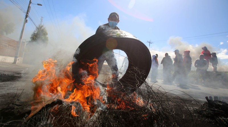 Un comunero de Alausí bloquea el paso de vehículos en la Panamericana Sur, durante el segundo día del paro. Foto: Julio Estrella / El Comercio