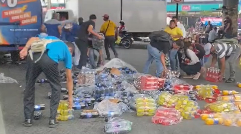 Un video en redes sociales captó el accionar de varias personas que ayudaron al conductor de un camión a reponer las botellas que cayeron a la vía. Foto: Captura