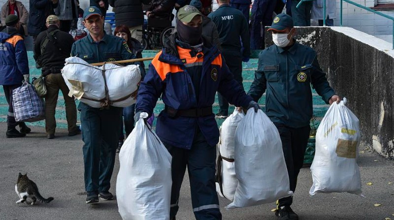 Socorristas rusos llevan bolsas con pertenencias de los residentes mientras evacuan una pensión geriátrica en la ciudad de Jersón este 5 de noviembre. Foto: EFE