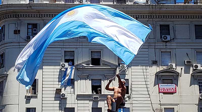 Seguidores de la Selección de Argentina esperan el paso de los jugadores, en la celebración de su victoria en el Mundial de Qatar 2022, en una calle de Buenos Aires. Foto: EFE