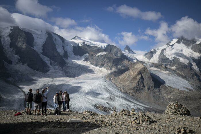 Imagen de archivo de turistas frente a una montaña en Suiza, país que vive de escasez de nieve. Foto: EFE
