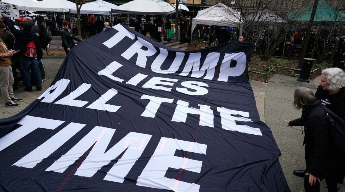 Manifestantes muestran mensajes en contra del expresidente estadounidense Donald Trump en inmediaciones de los tribunales de Nueva York, este 4 de abril de 2023. Foto: EFE