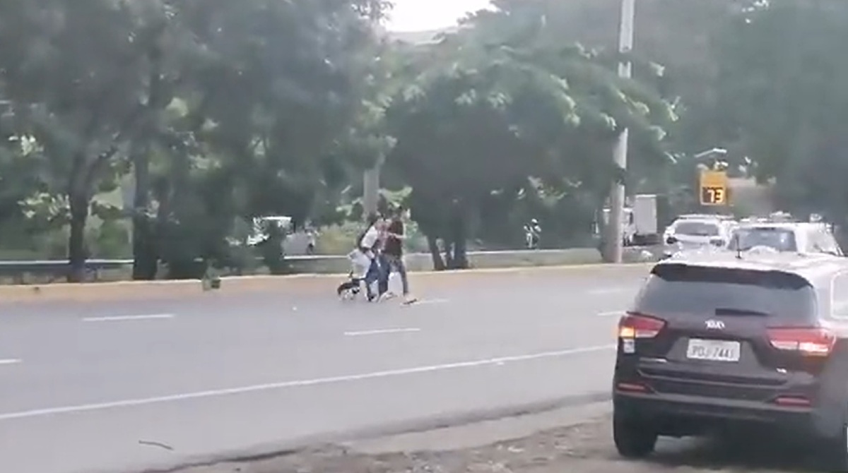 El video publicado en Twitter muestra a una mujer que cruza corriendo la vía con un niño. Foto: Captura de video